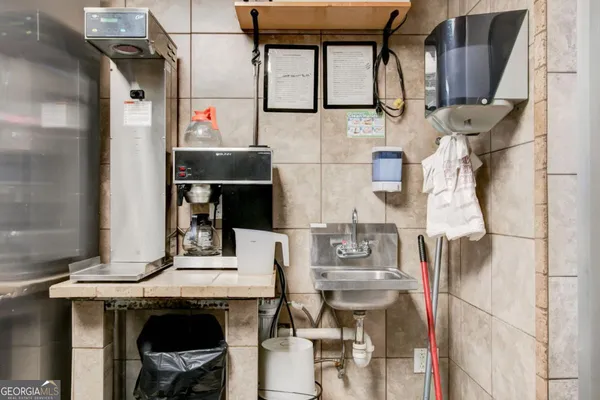 a front view of a bathroom with sink and mirror