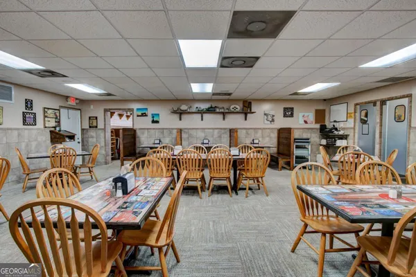 a dining room with furniture and a chandelier