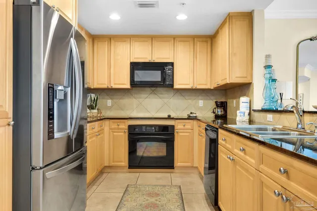 a kitchen with stainless steel appliances granite countertop a refrigerator sink and cabinets