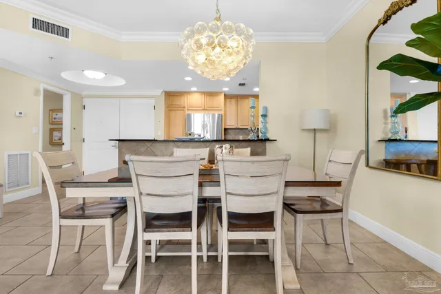 a view of a dining room with furniture and chandelier