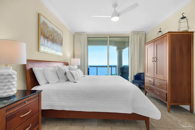 a bedroom with a bed and a refrigerator