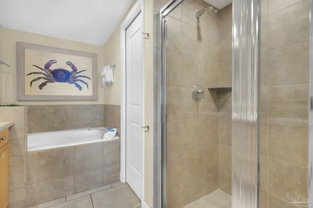 a bathroom with a painting on the wall and shower