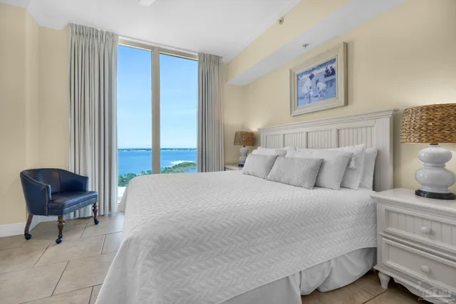 a bedroom with a bed and chair