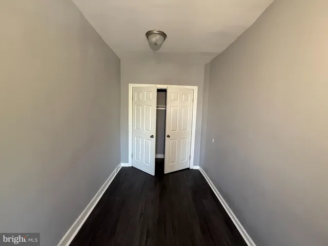 a view of small space with wooden floor and a window