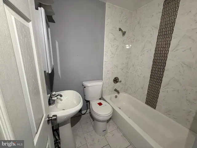 a bathroom with a toilet and a tub