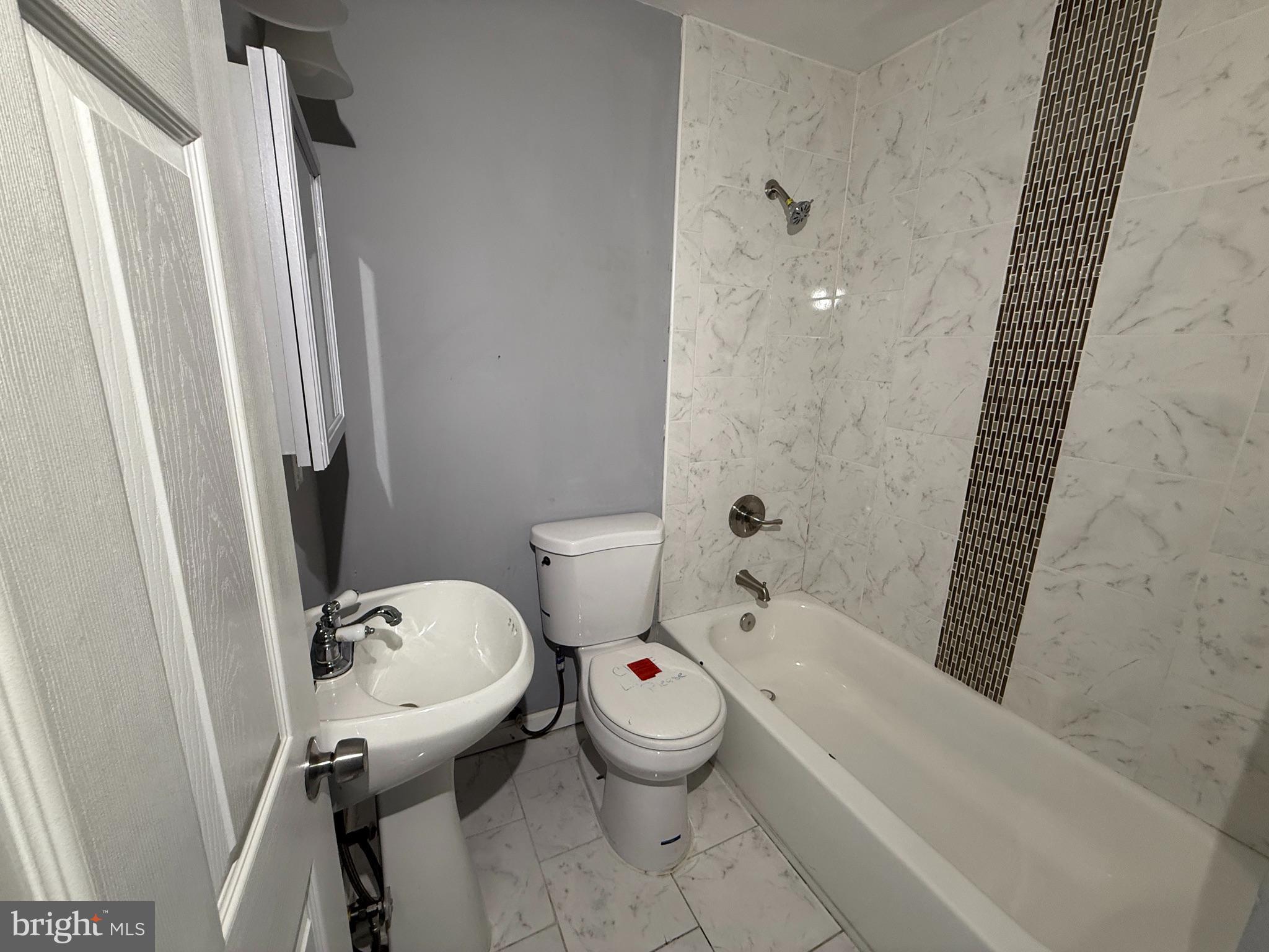1635 Normal Avenue Baltimore, MD 21213 - Photo 13 of 18 a bathroom with a toilet and a tub