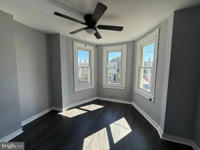 a view of wooden floor and windows in a room