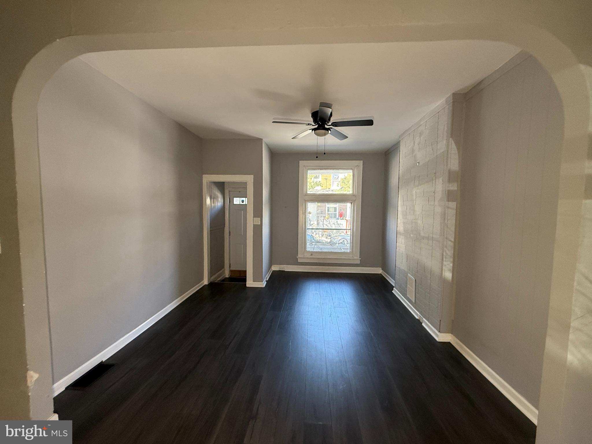 1635 Normal Avenue Baltimore, MD 21213 - Photo 2 of 18 a view of an empty room with wooden floor and a window