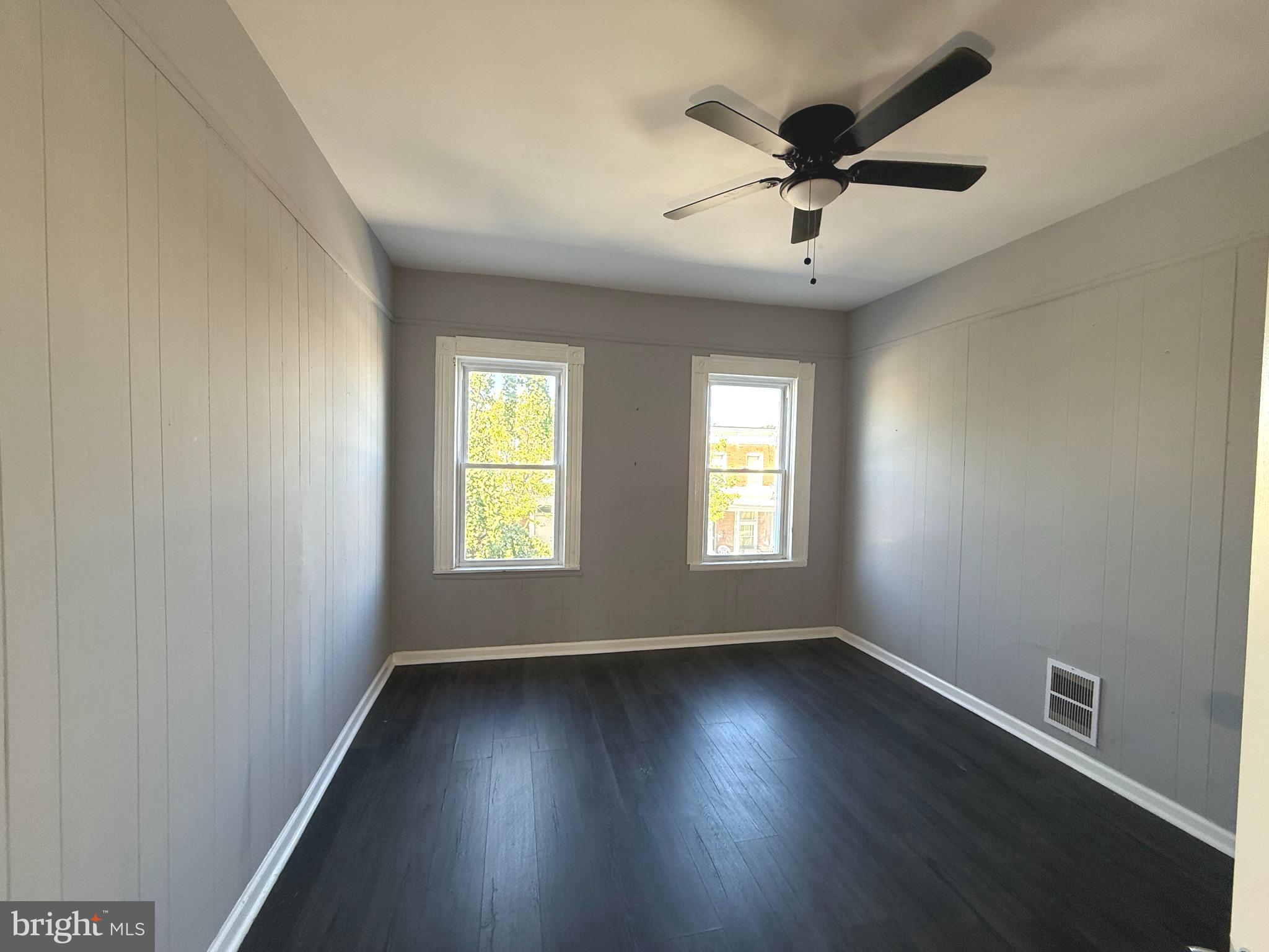 1635 Normal Avenue Baltimore, MD 21213 - Photo 9 of 18 an empty room with wooden floor and windows