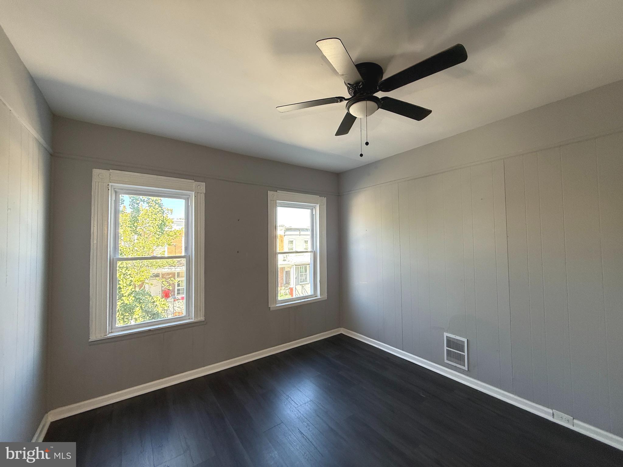 1635 Normal Avenue Baltimore, MD 21213 - Photo 10 of 18 a view of an empty room with wooden floor and a window