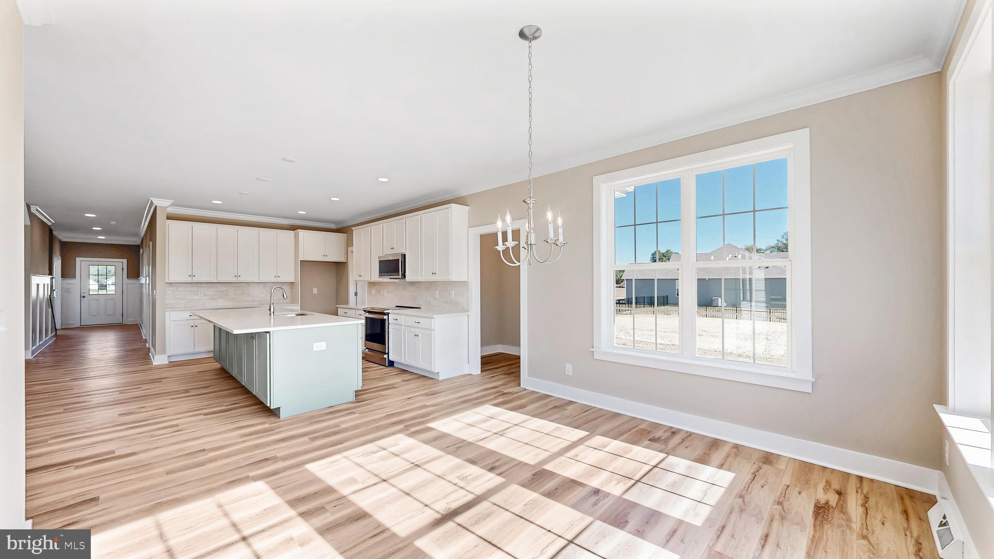 22012 Antlered Way Georgetown, DE 19947 - Photo 13 of 58 a view of kitchen with stainless steel appliances kitchen island white cabinets and wooden floor