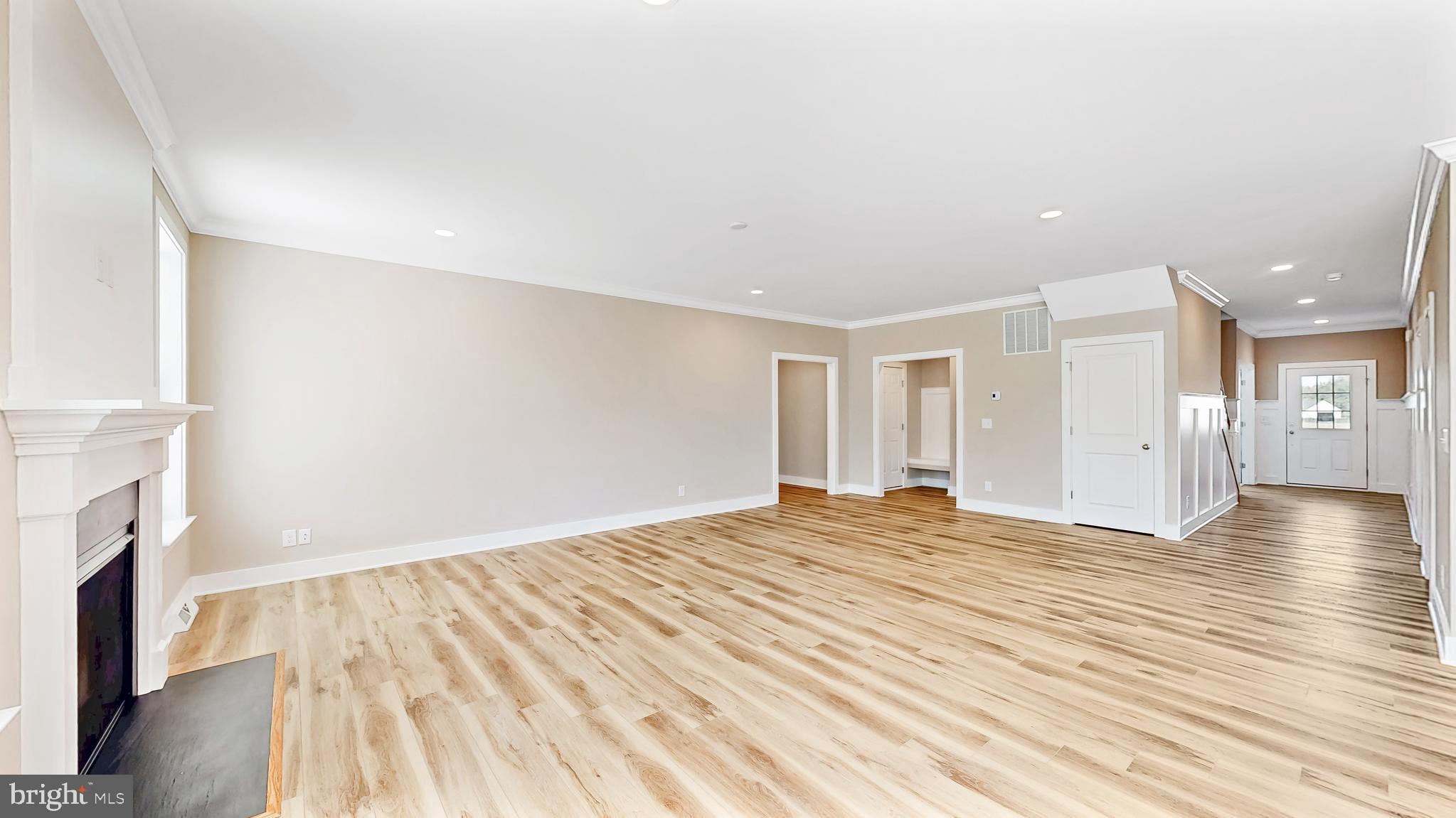 22012 Antlered Way Georgetown, DE 19947 - Photo 15 of 58 a view of empty room with wooden floor and fireplace
