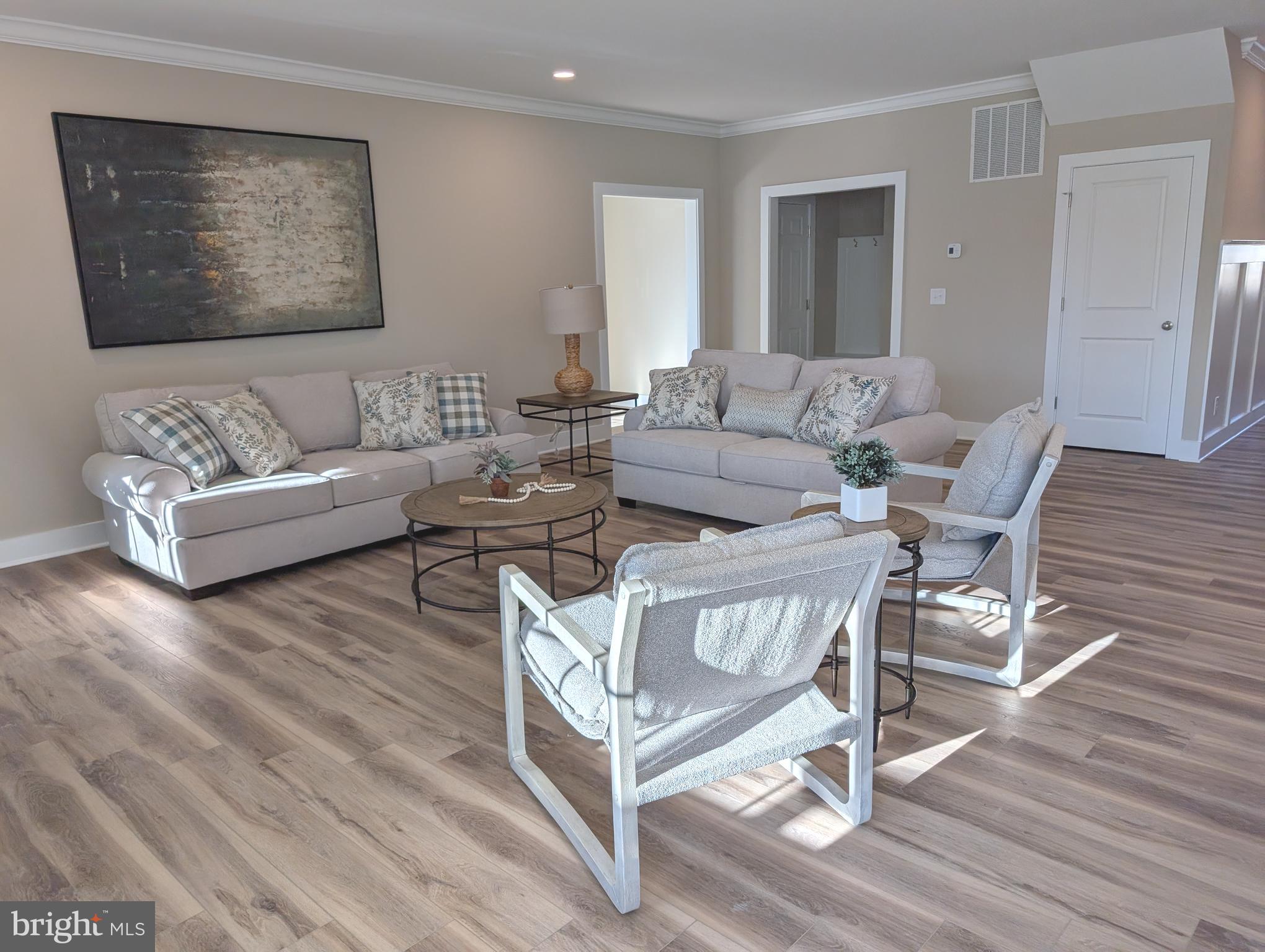 22012 Antlered Way Georgetown, DE 19947 - Photo 16 of 58 a living room with furniture and a wooden floor