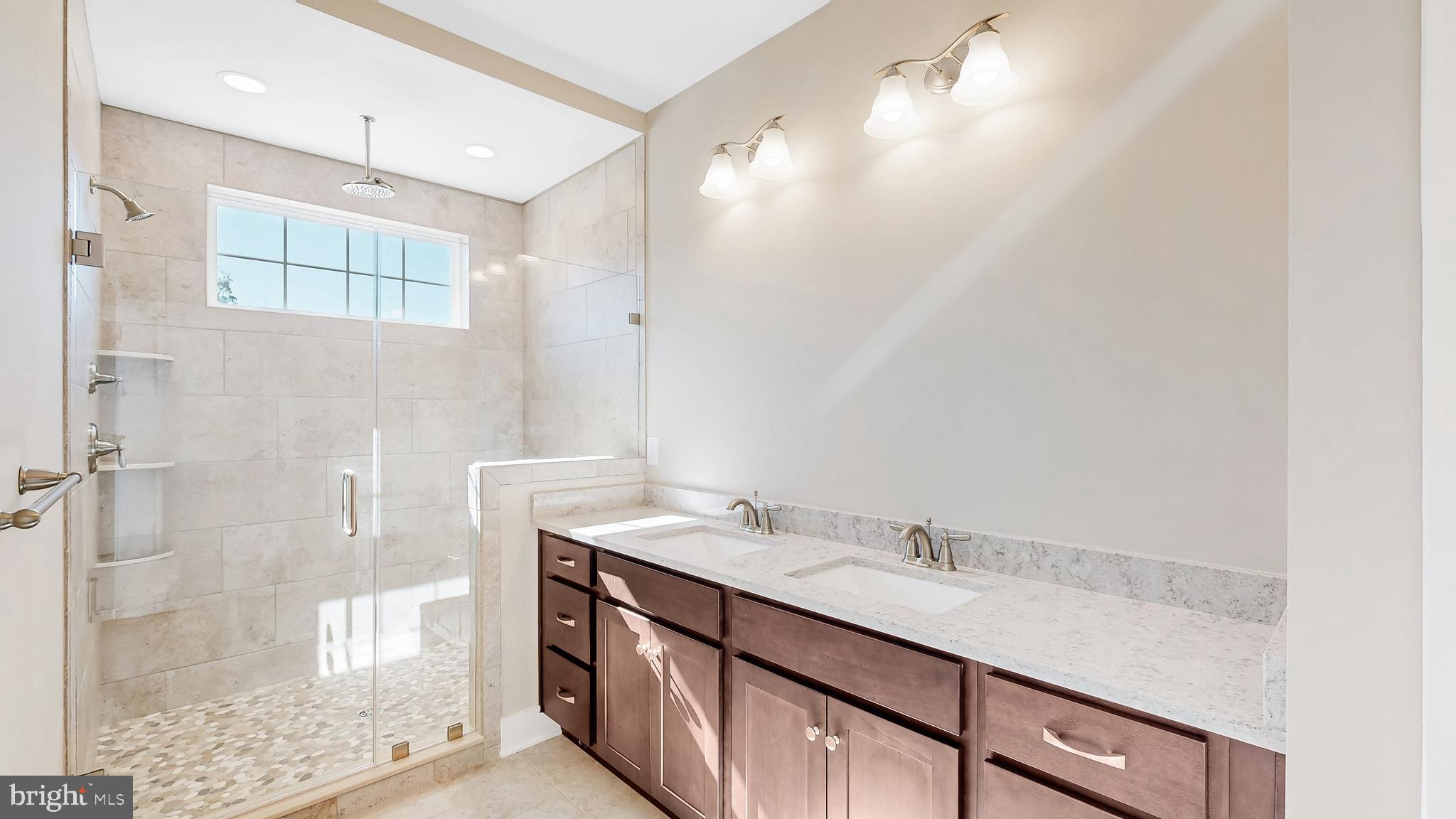 22012 Antlered Way Georgetown, DE 19947 - Photo 22 of 58 a bathroom with a granite countertop sink a shower and a mirror