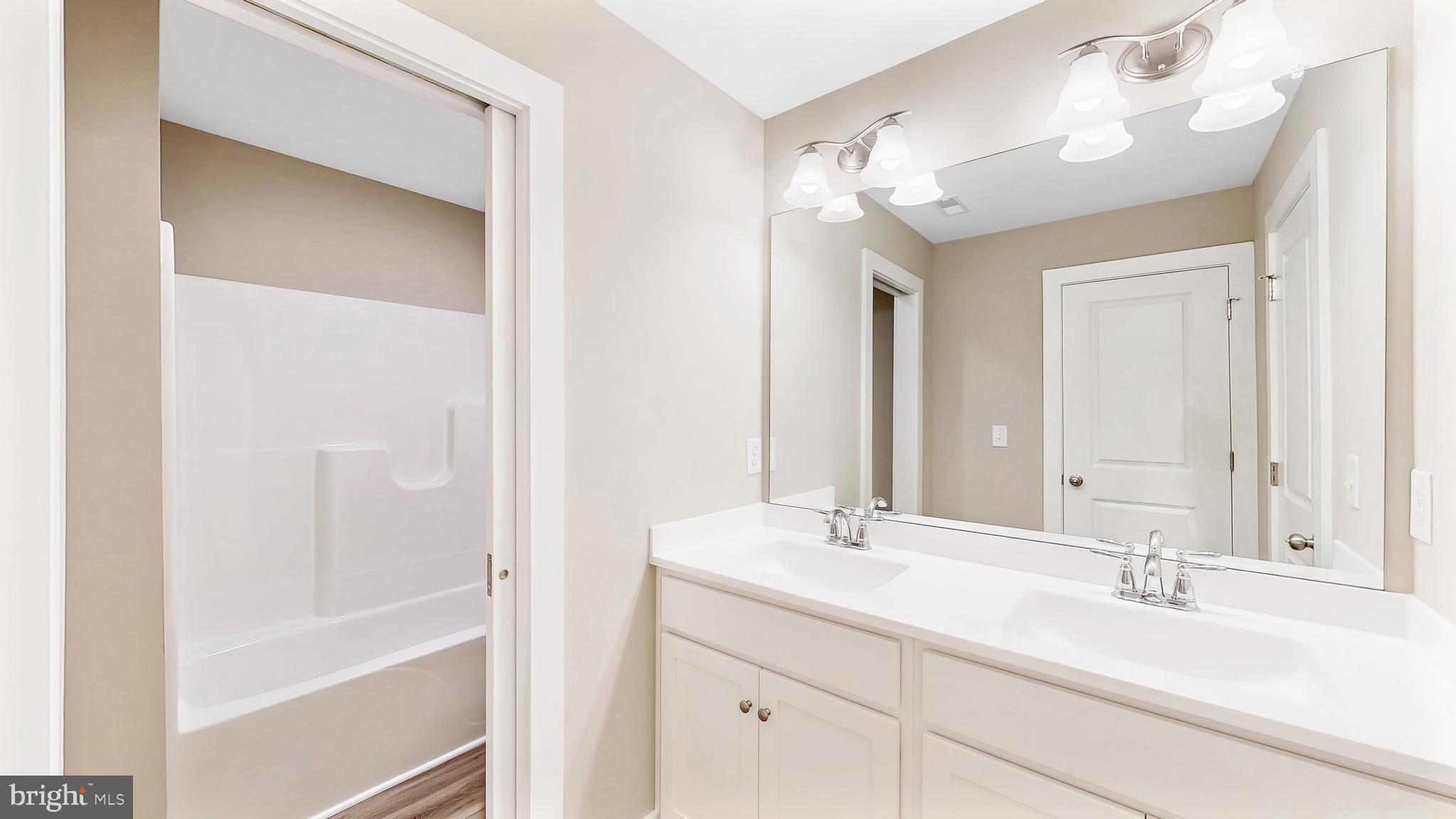22012 Antlered Way Georgetown, DE 19947 - Photo 25 of 58 a bathroom with a double vanity sink mirror and