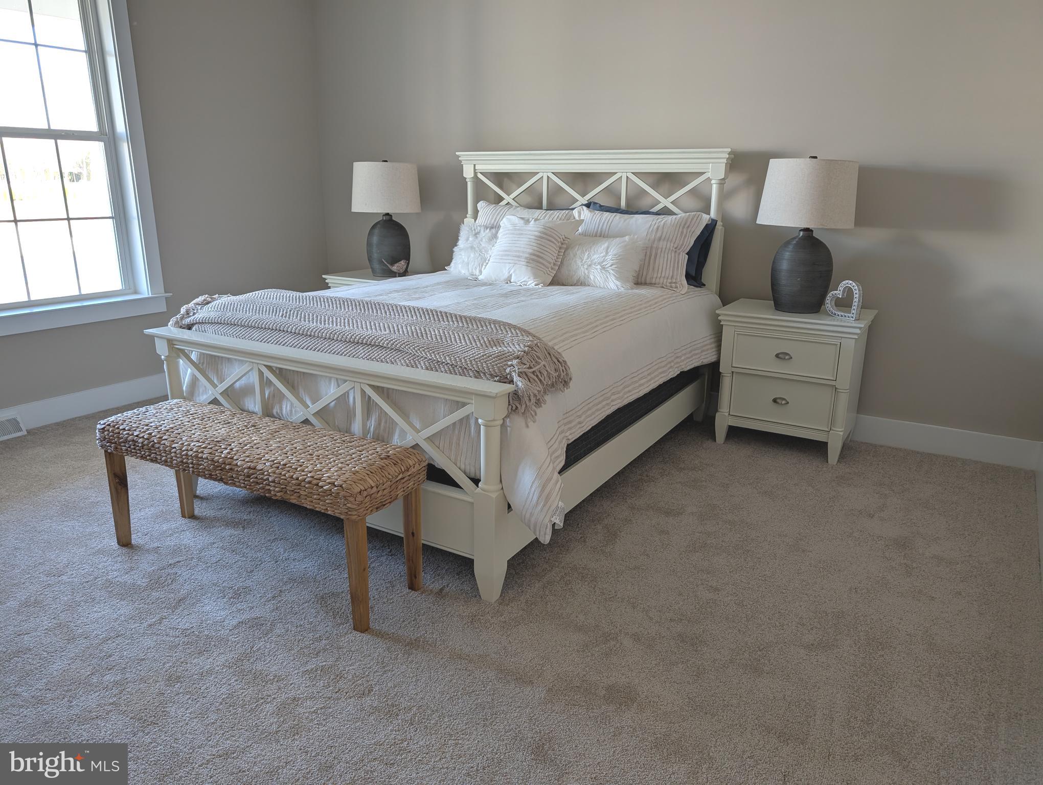 22012 Antlered Way Georgetown, DE 19947 - Photo 26 of 58 a bedroom with a bed and a night stand