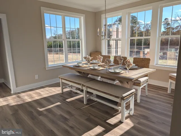 a view of a dining room with furniture and window