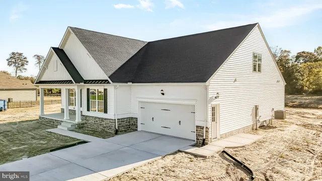 a view of a house with snow on the road