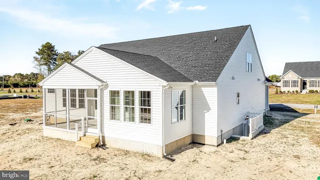 a view of a grey house with a outdoor space