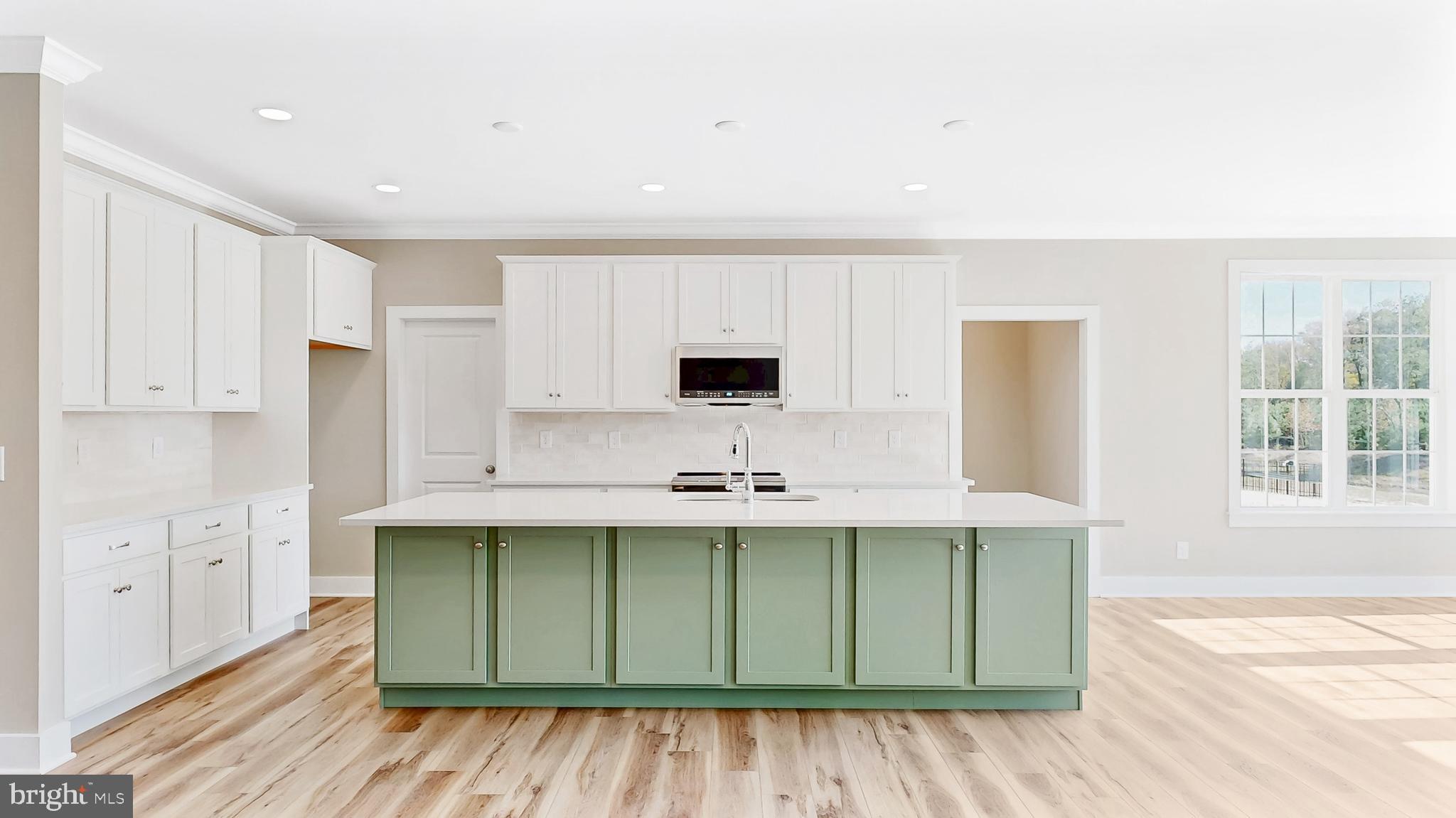 22012 Antlered Way Georgetown, DE 19947 - Photo 7 of 58 a kitchen with stainless steel appliances granite countertop a sink and cabinets with wooden floor