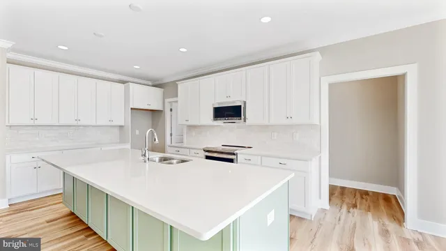 a kitchen with a sink a stove and cabinets
