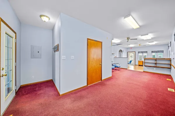 a view of an empty room with a kitchen