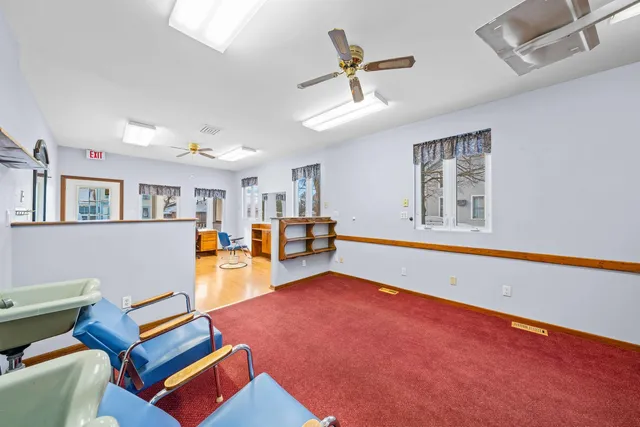 a living room with furniture a rug and a window