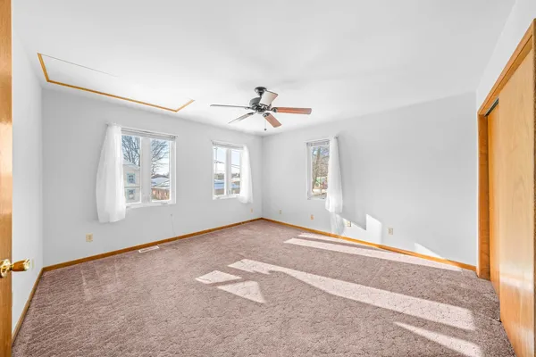 a view of a room with a ceiling fan and a window