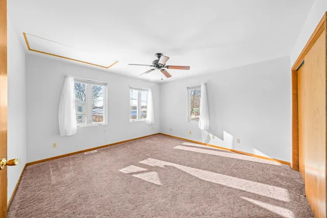 a view of a room with a ceiling fan and a window