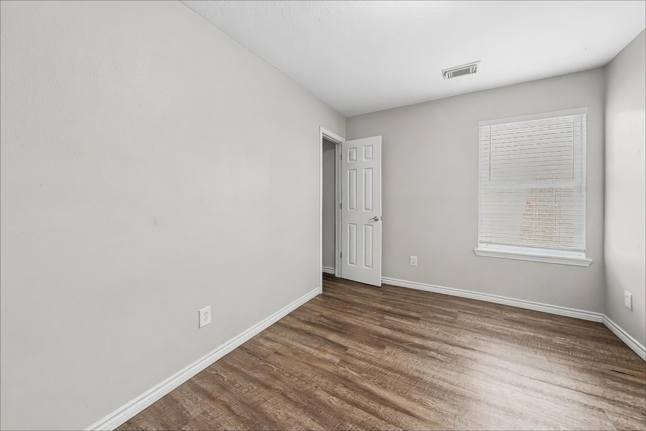 2423 Lofty Falls Court Spring, TX 77386 - Photo 12 of 15 a view of an empty room with wooden floor and a window