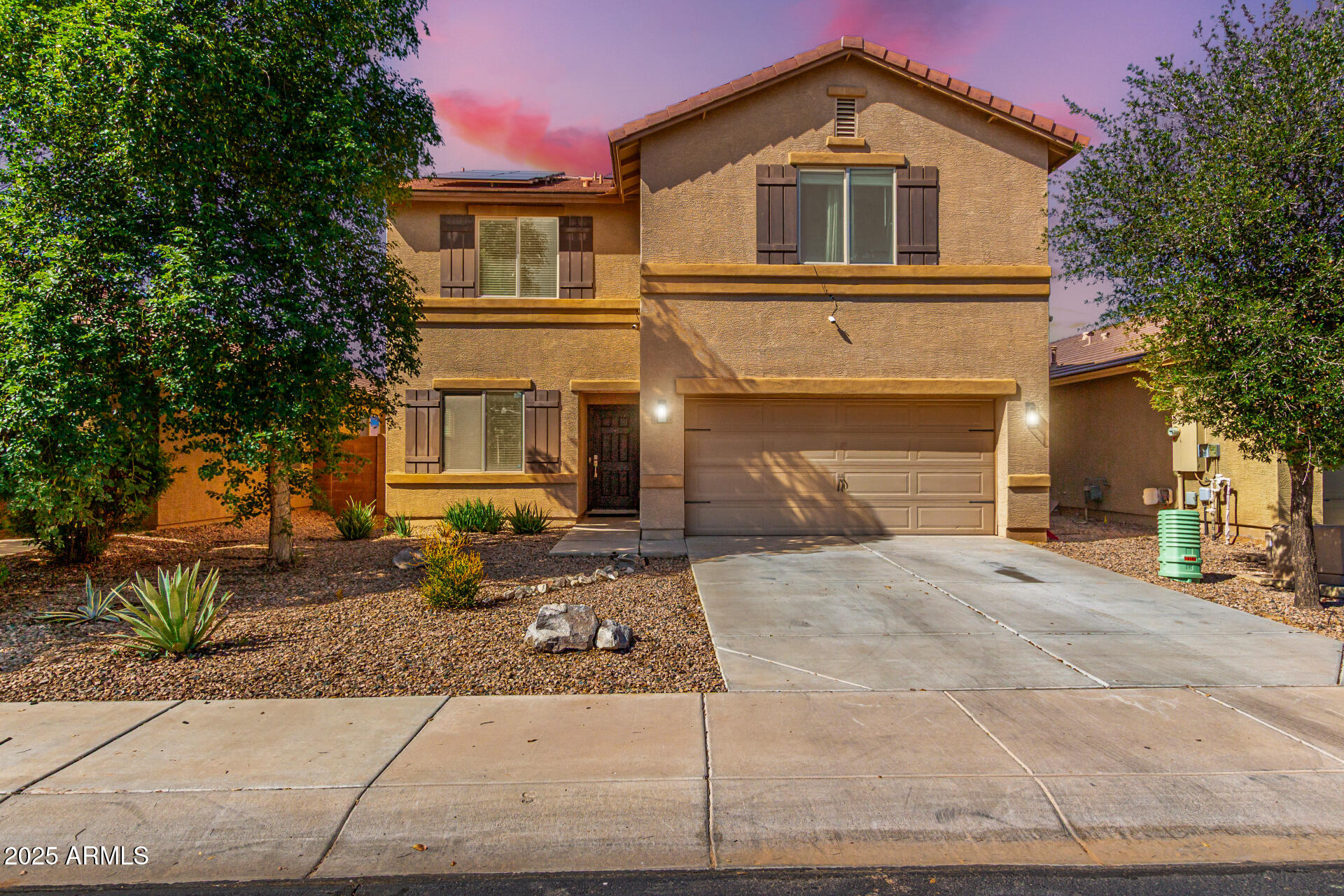 18586 North Lariat Road Maricopa, AZ 85138 - Photo 1 of 16 a front view of a house with a garden