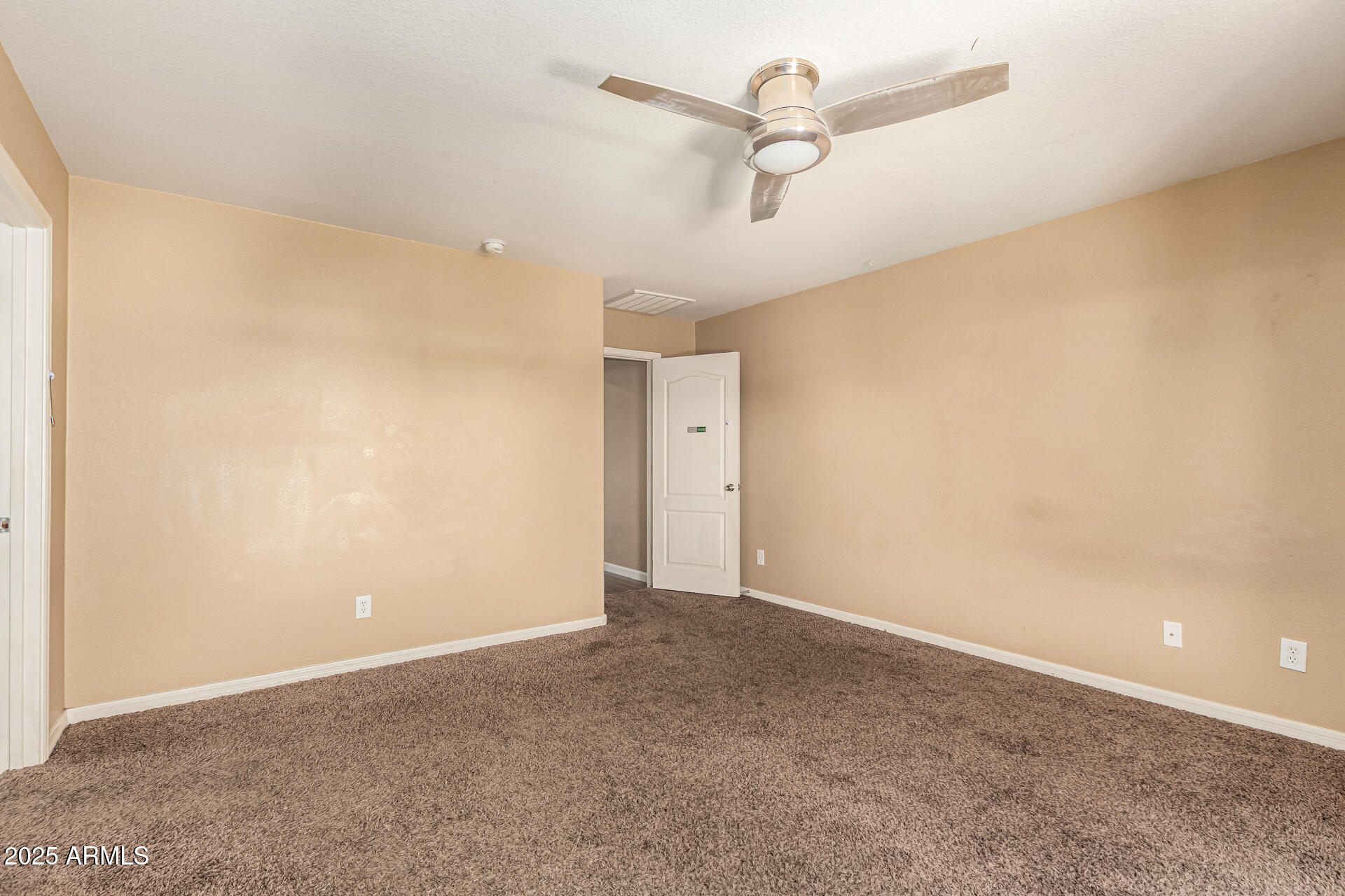 18586 North Lariat Road Maricopa, AZ 85138 - Photo 11 of 16 an empty room with a ceiling fan and a window