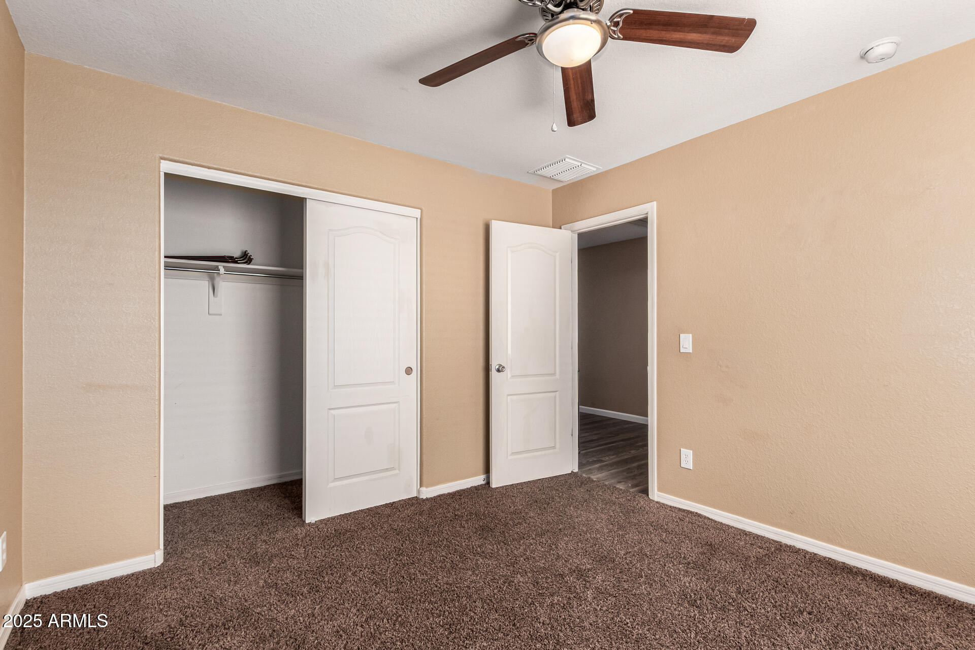 18586 North Lariat Road Maricopa, AZ 85138 - Photo 13 of 16 a view of an empty room with a ceiling fan