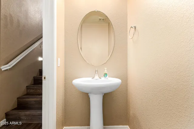 a bathroom with a sink a mirror and vanity
