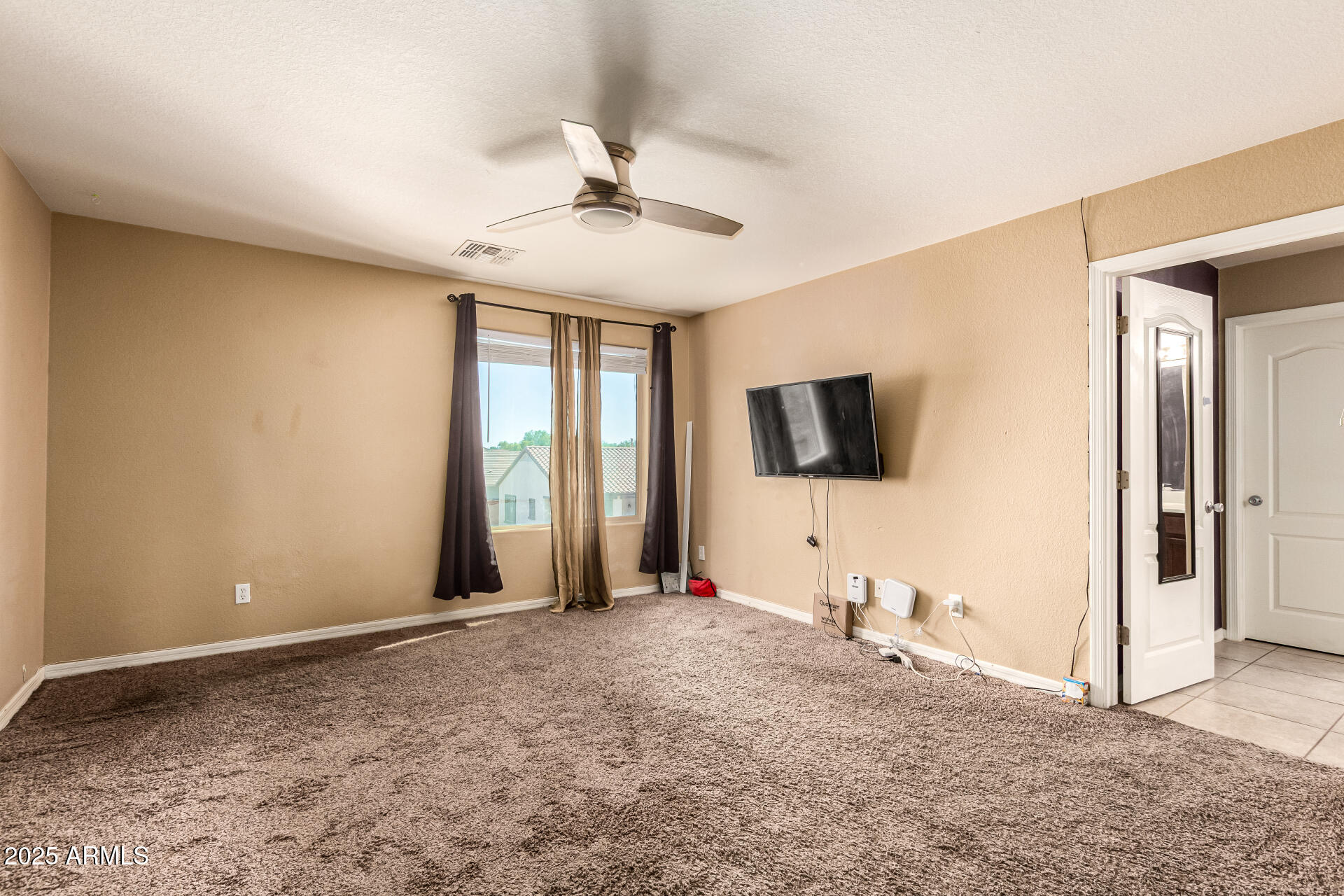 18586 North Lariat Road Maricopa, AZ 85138 - Photo 10 of 16 a view of a livingroom with wooden floor and a flat screen tv