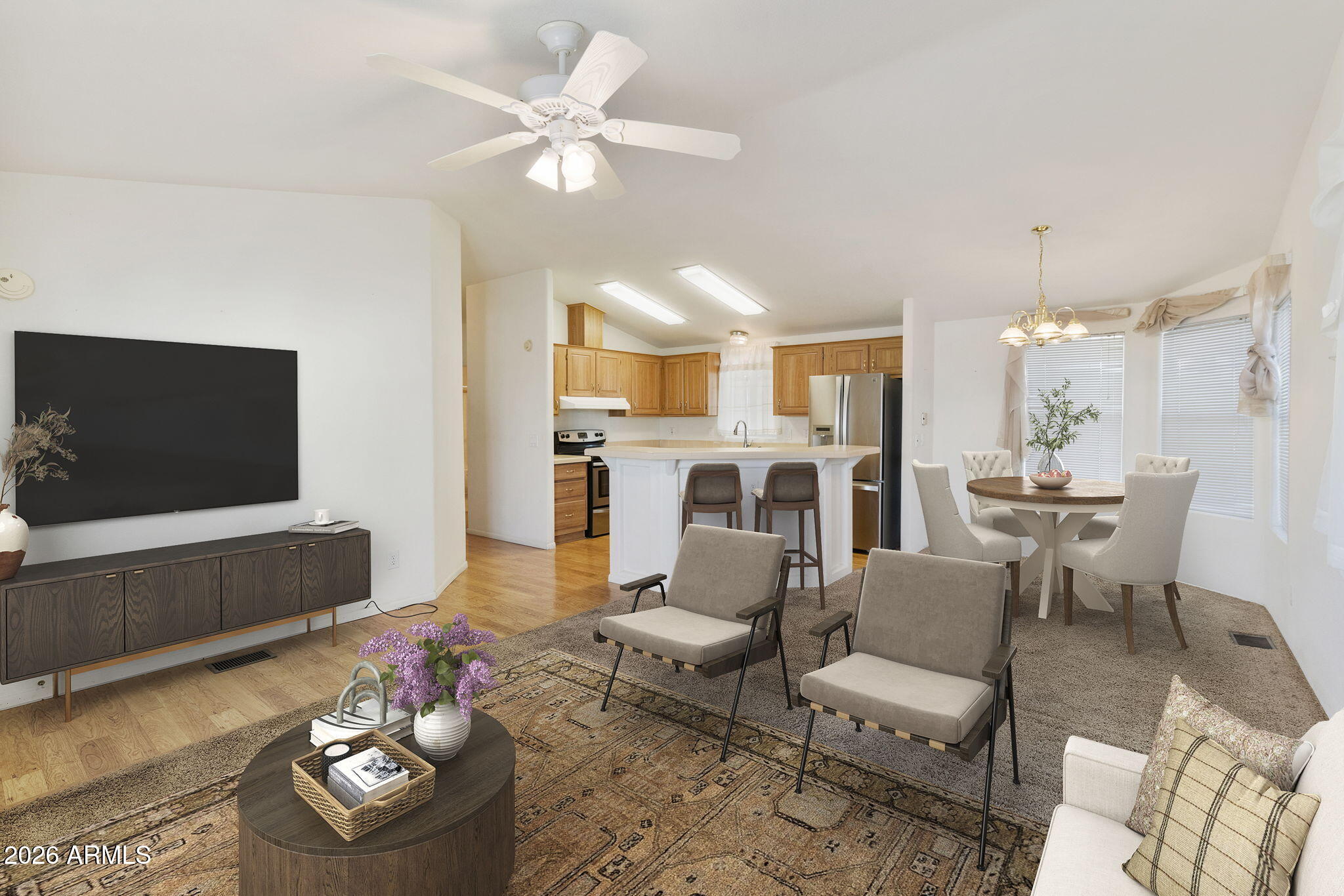 3700 South Tomahawk Road, Unit 73 Apache Junction, AZ 85119 - Photo 33 of 49 a living room with furniture kitchen view and a flat screen tv