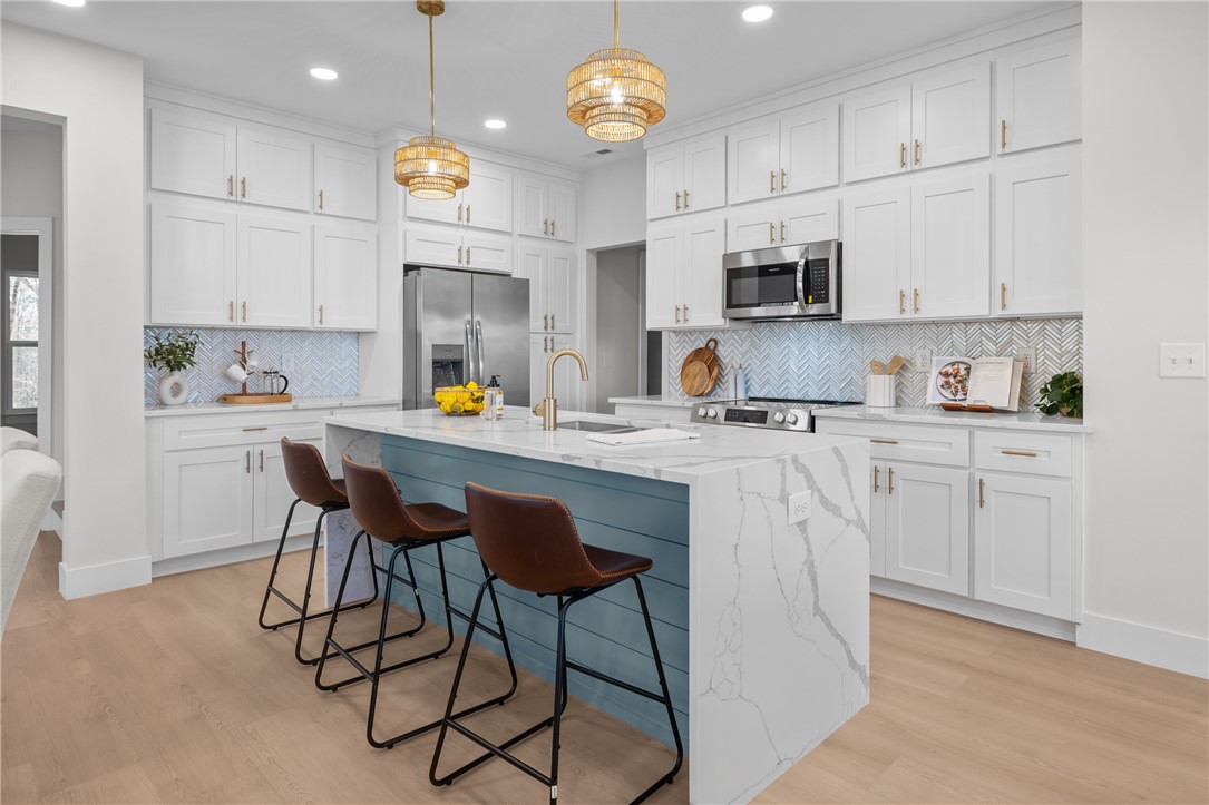 322 Oconee Avenue Westminster, SC 29693 - Photo 4 of 43 This bright kitchen features an island, ample cabinetry, and sleek appliances.