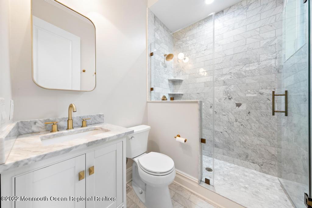 3 Sugar Maple Lane Rumson, NJ 07760 - Photo 22 of 53 a bathroom with a sink a toilet and a mirror