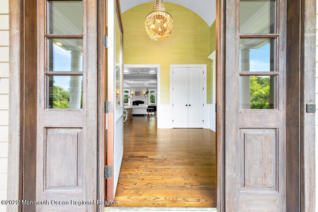 3 Sugar Maple Lane Rumson, NJ 07760 - Photo 4 of 53 hallway view with wooden floor and a bathroom