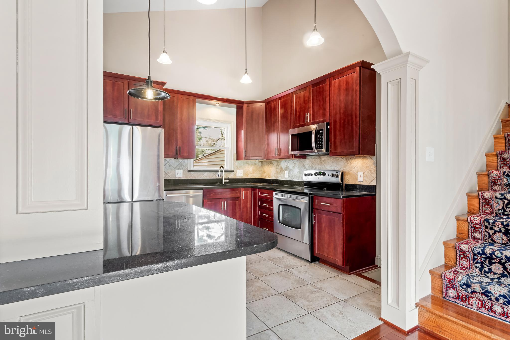 947 Beaverbank Circle Towson, MD 21286 - Photo 12 of 63 a kitchen with stainless steel appliances granite countertop a refrigerator a stove a sink and a microwave