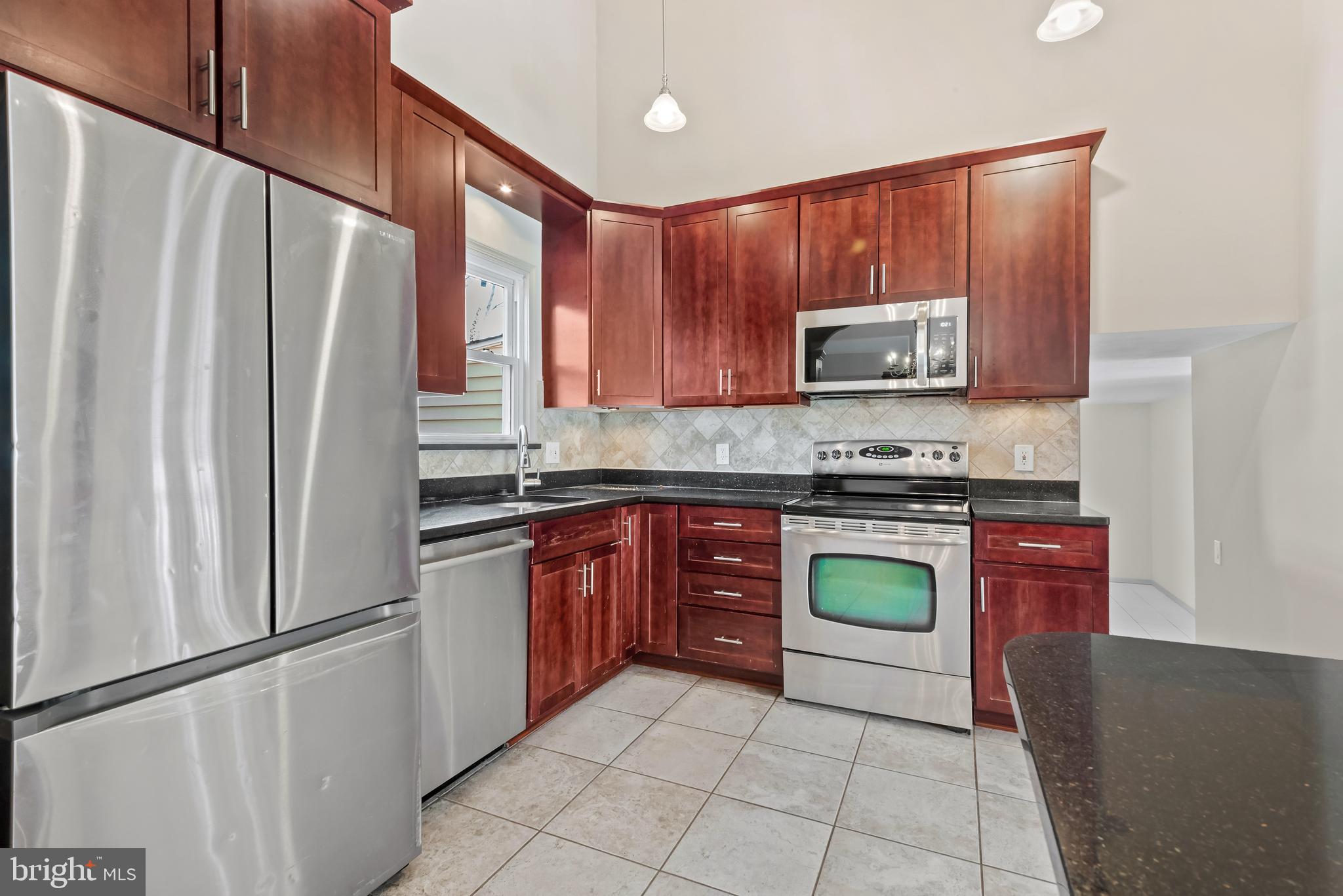 947 Beaverbank Circle Towson, MD 21286 - Photo 14 of 63 a kitchen with stainless steel appliances granite countertop a refrigerator sink and stove