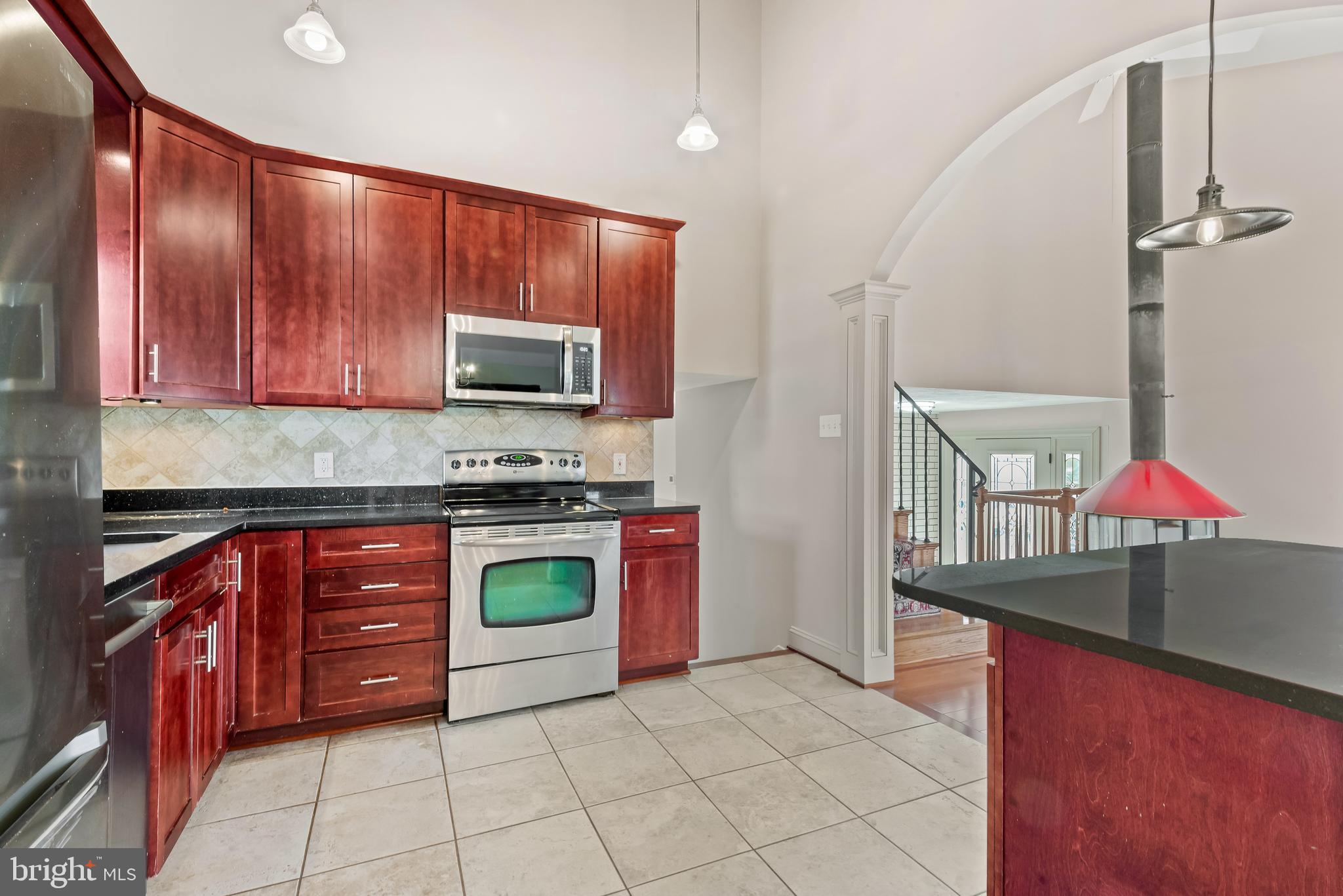 947 Beaverbank Circle Towson, MD 21286 - Photo 15 of 63 a kitchen with stainless steel appliances granite countertop a stove a sink and a microwave
