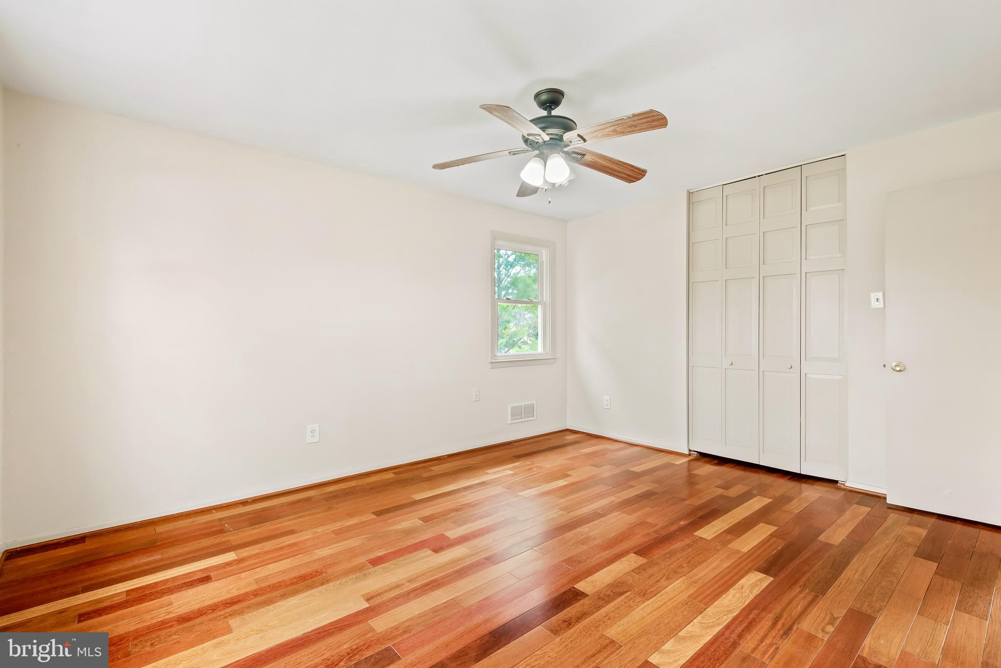 947 Beaverbank Circle Towson, MD 21286 - Photo 20 of 63 an empty room with wooden floor fan and windows
