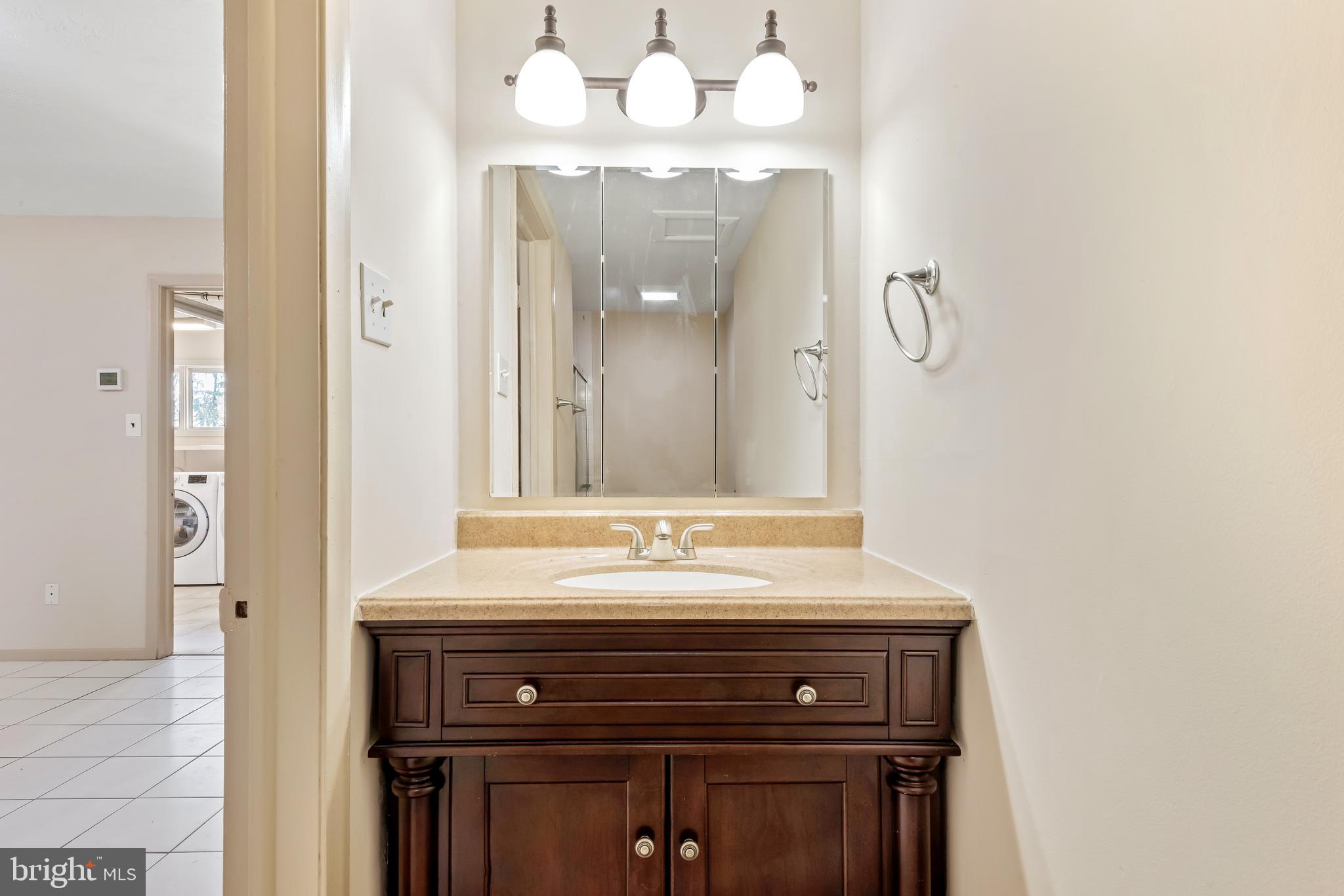947 Beaverbank Circle Towson, MD 21286 - Photo 34 of 63 a bathroom with a sink and a mirror