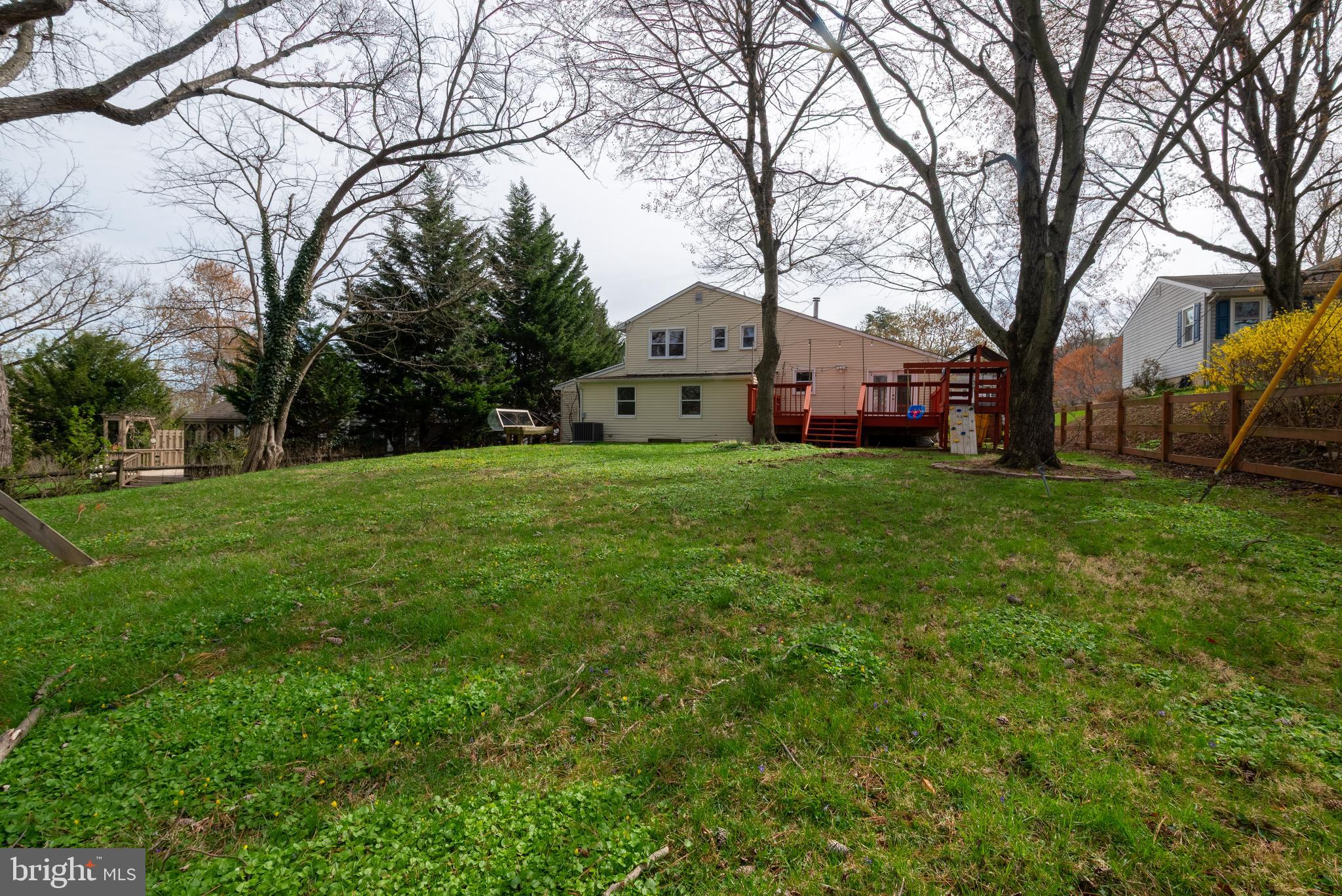 947 Beaverbank Circle Towson, MD 21286 - Photo 57 of 63 a front view of a house with a yard and trees