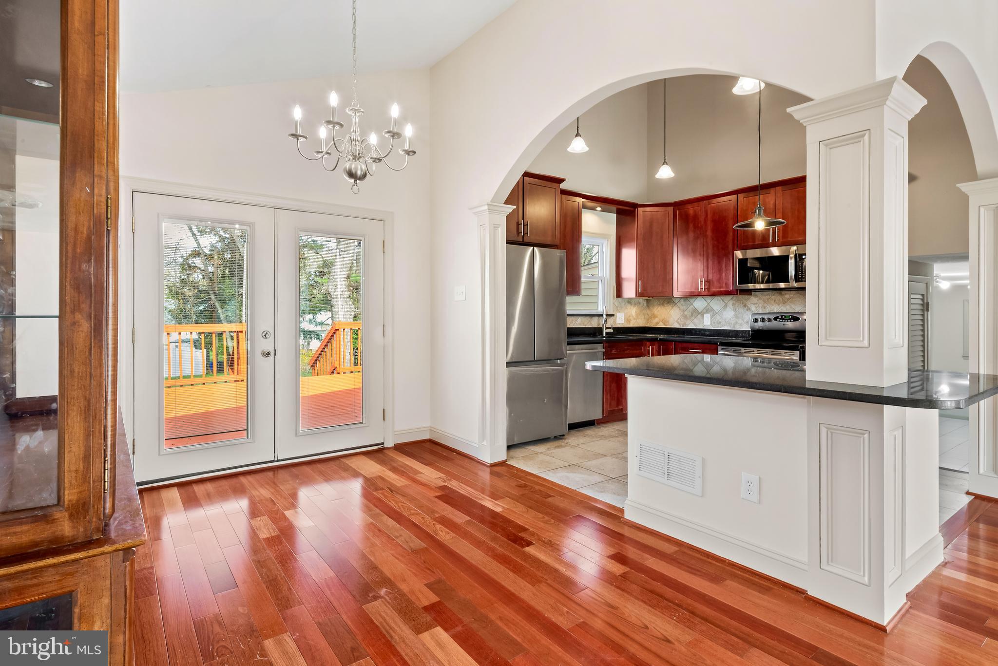 947 Beaverbank Circle Towson, MD 21286 - Photo 9 of 63 a open kitchen with stainless steel appliances granite countertop a refrigerator stove top oven and cabinets with wooden floor