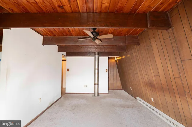 a view of a room with wooden walls
