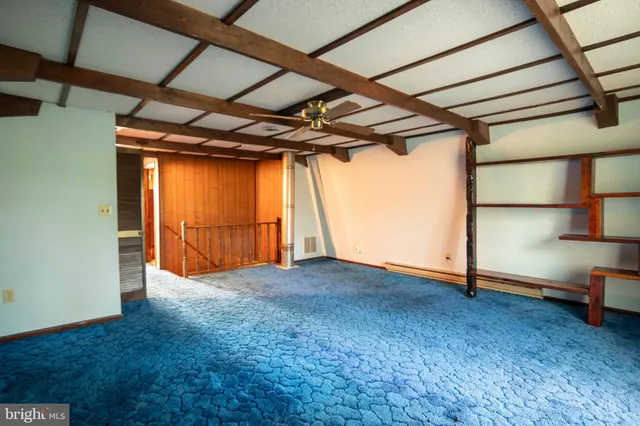 a view of a swimming pool with a patio and a yard