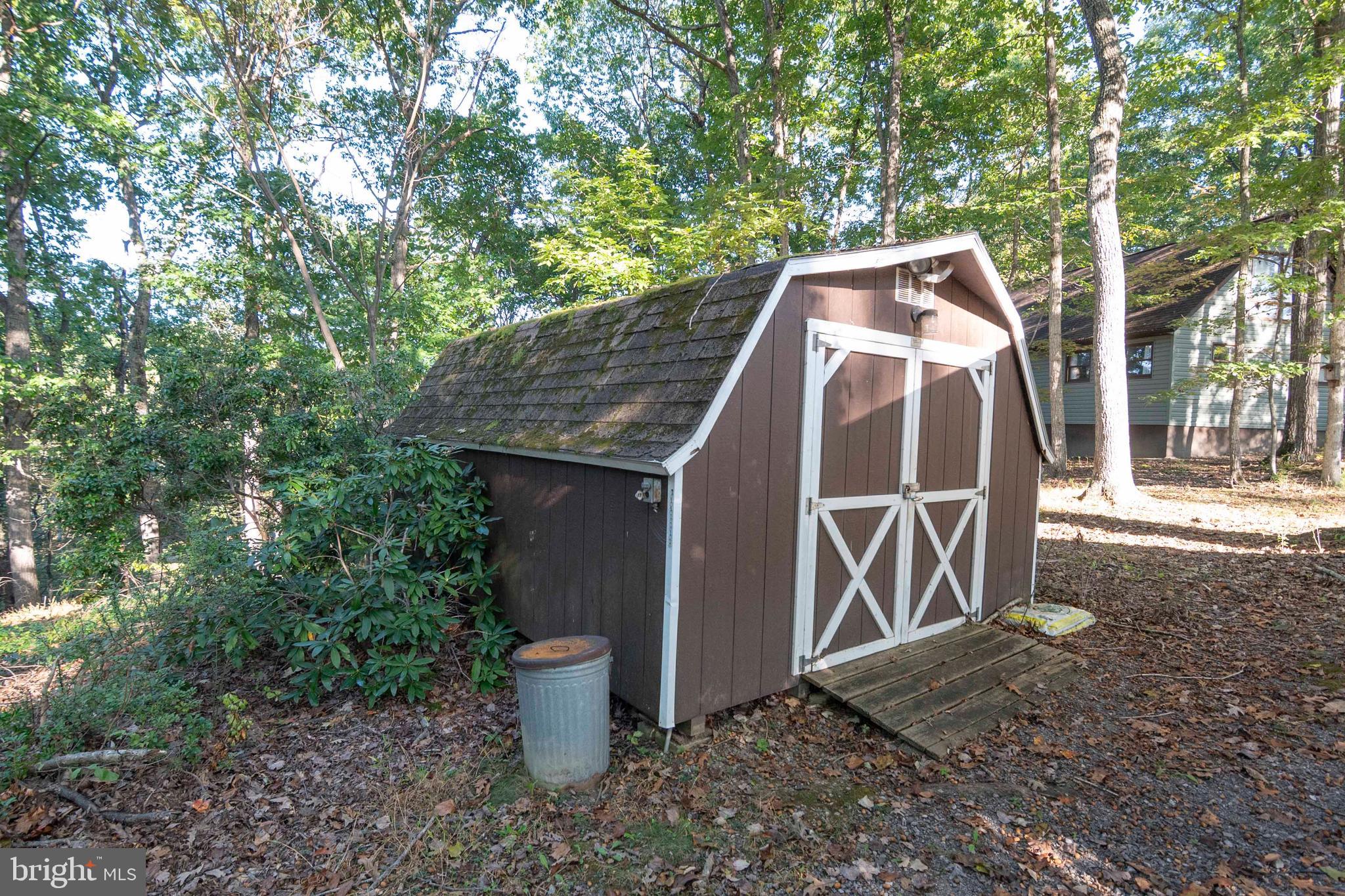 458 Hobbs Knob Road Front Royal, VA 22630 - Photo 48 of 94 a view of a wooden house with a yard and large trees