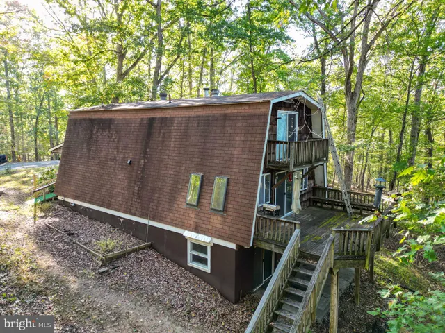 a view of a field with a lush green forest